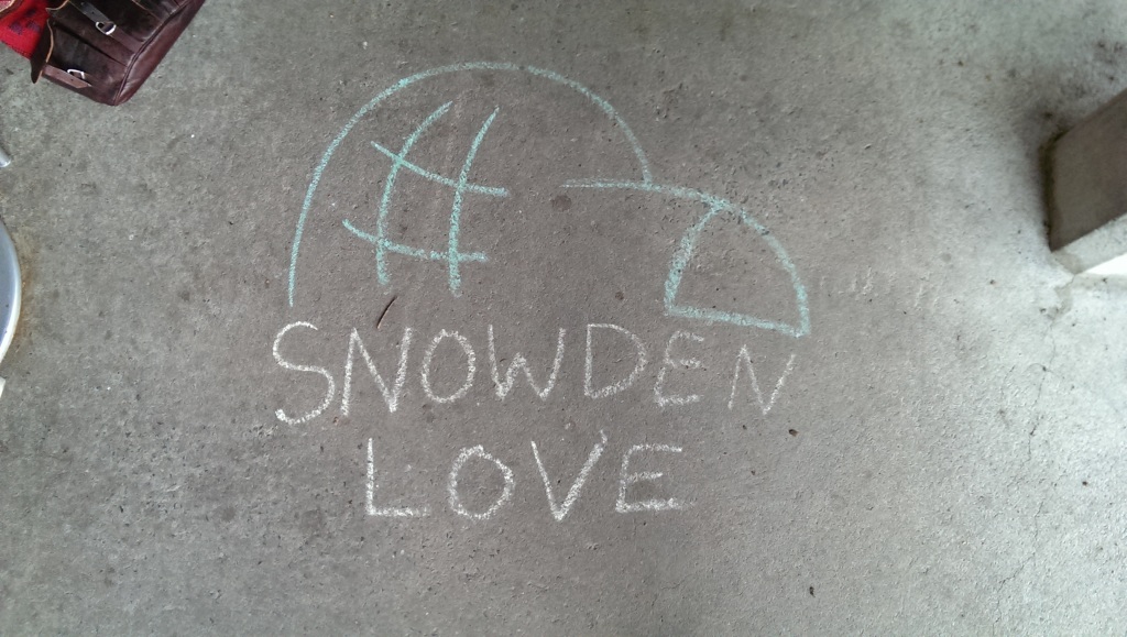 Chalk words 'Snowden Love' on the sidewalk in Carrboro, NC.