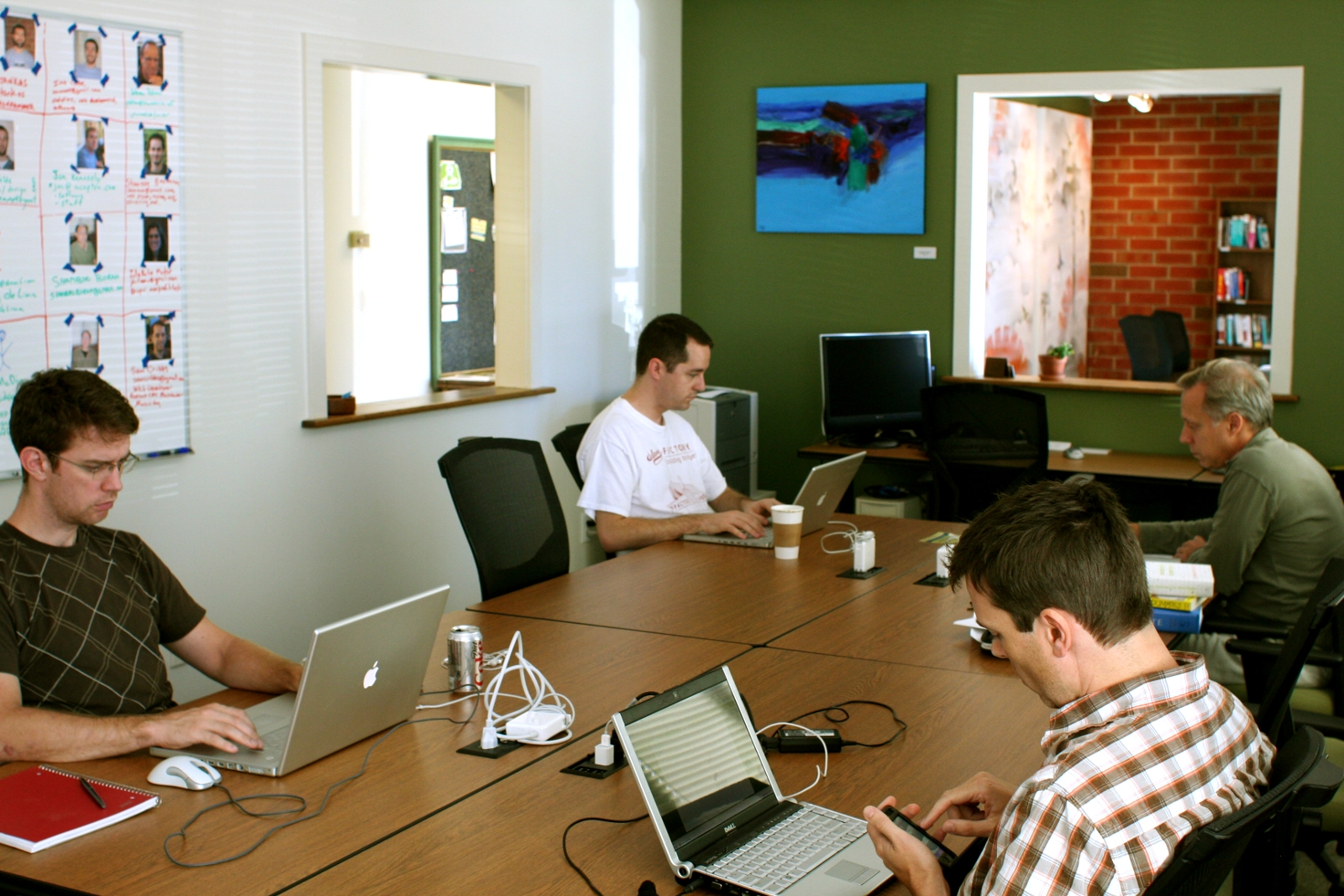 Members working together at shared tables inside Carrboro Creative Coworking in Carrboro, North Carolina, circa 2008